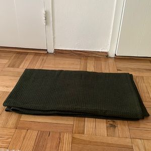Thin, forest green waffle knit throw blanket